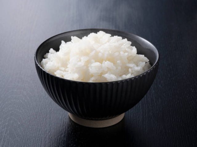 Rice on a black background, taken from an angle